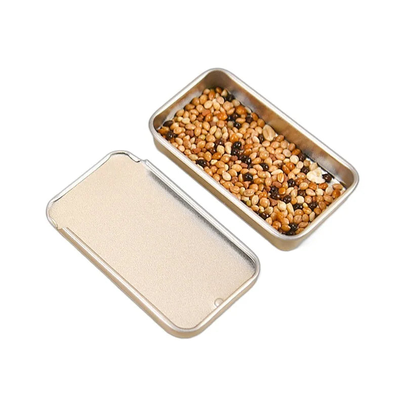 handhållen foderdosa i metall for fågelträning