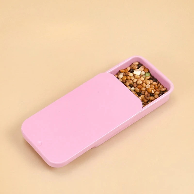 handhållen foderdosa i metall for fågelträning